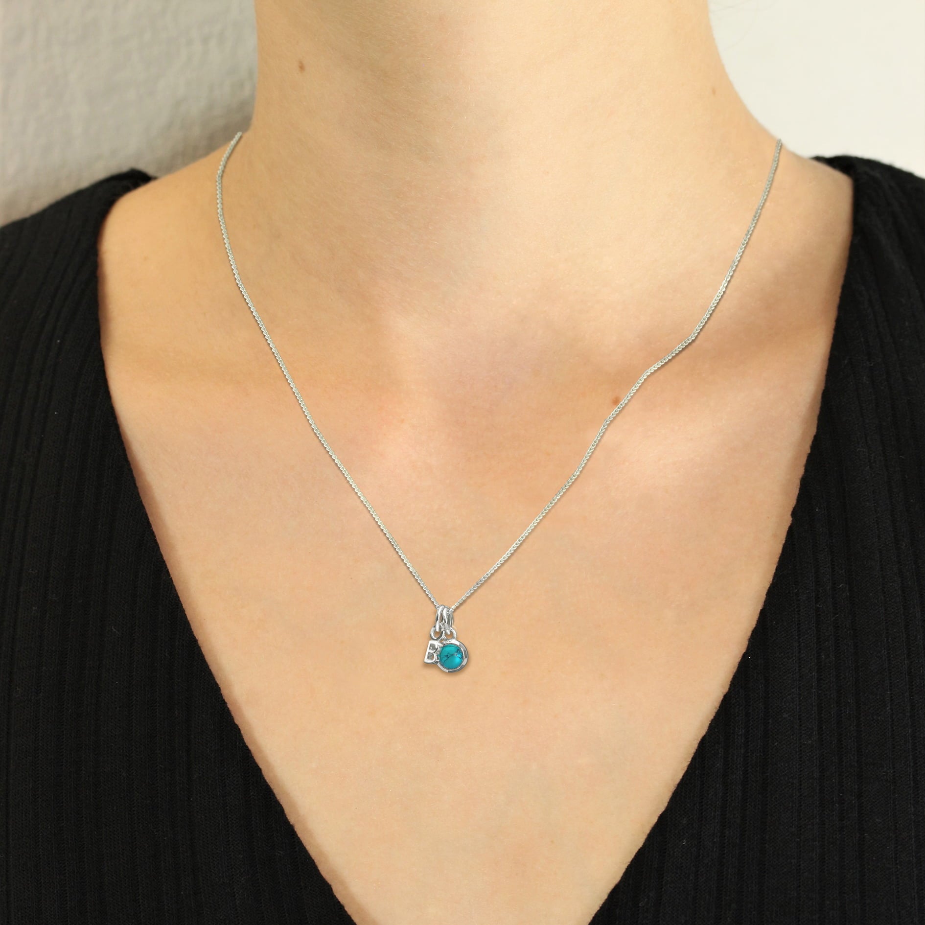 small silver alphabet charm for birthstone necklace on model
