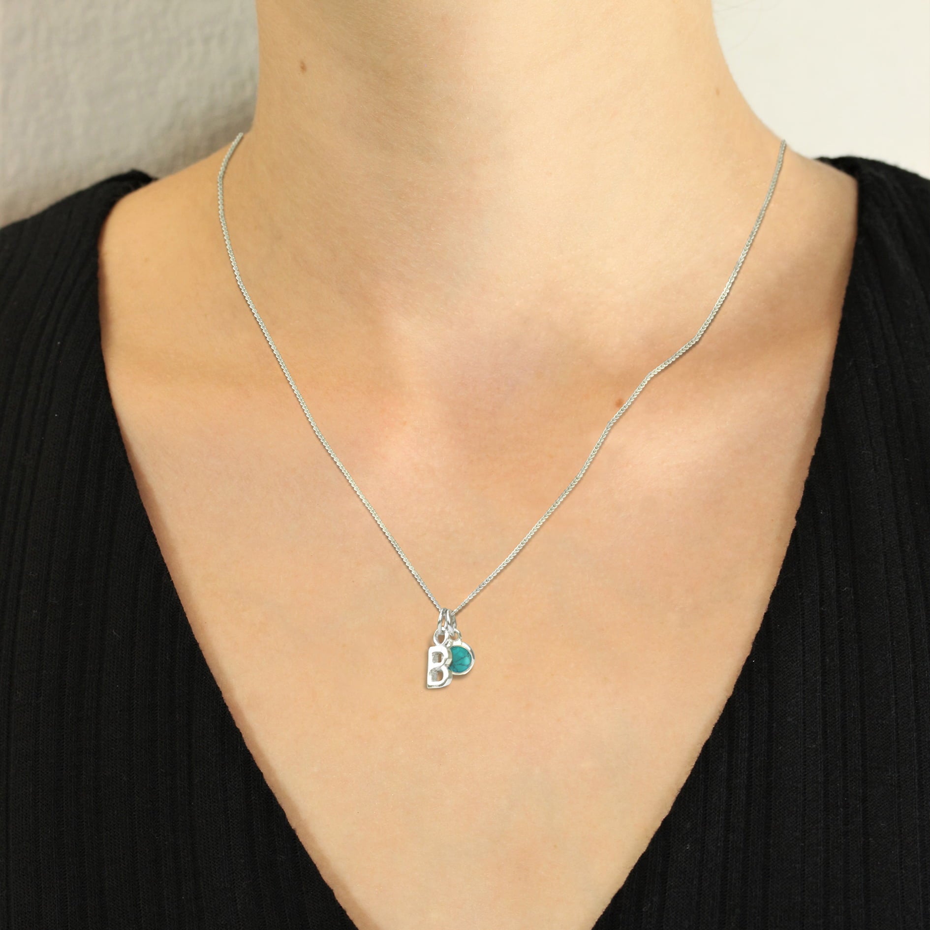 Big silver alphabet charm for necklace on model