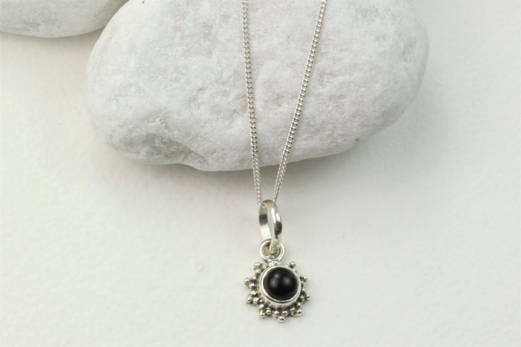 Star Motif Pendant Necklace with Black Onyx in Sterling Silver