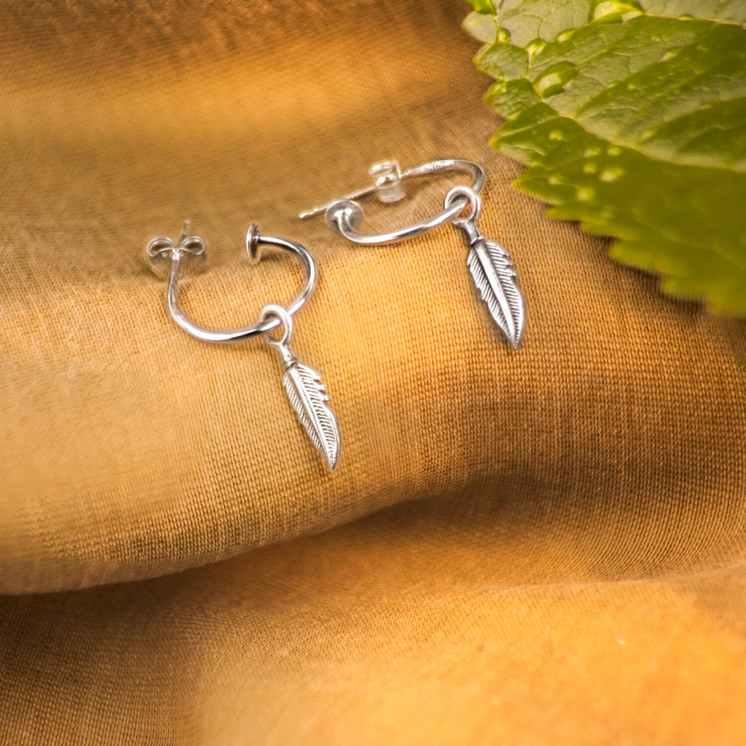 Open Hoop Earrings with Feather Charm in Sterling Silver